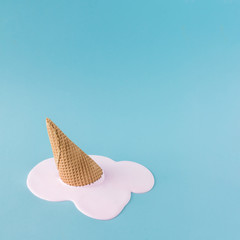Overhead pink ice cream on pastel blue background. Minimalistic summer food concept.