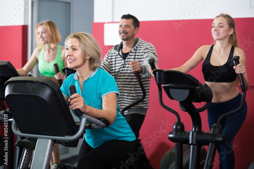 adults in gym working out at group class