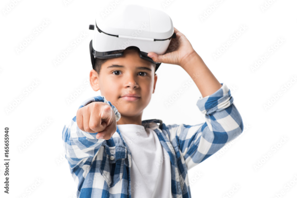 african american boy wearing virtual reality headset and pointing at camera isolated on white african american boy wearing virtual reality headset and pointing at camera isolated on white