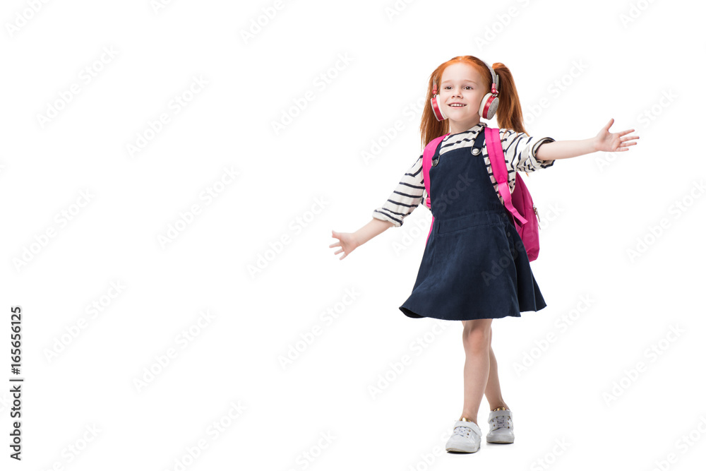 Φωτογραφία beautiful happy redhead schoolgirl listening music in headphones isolated on whi
