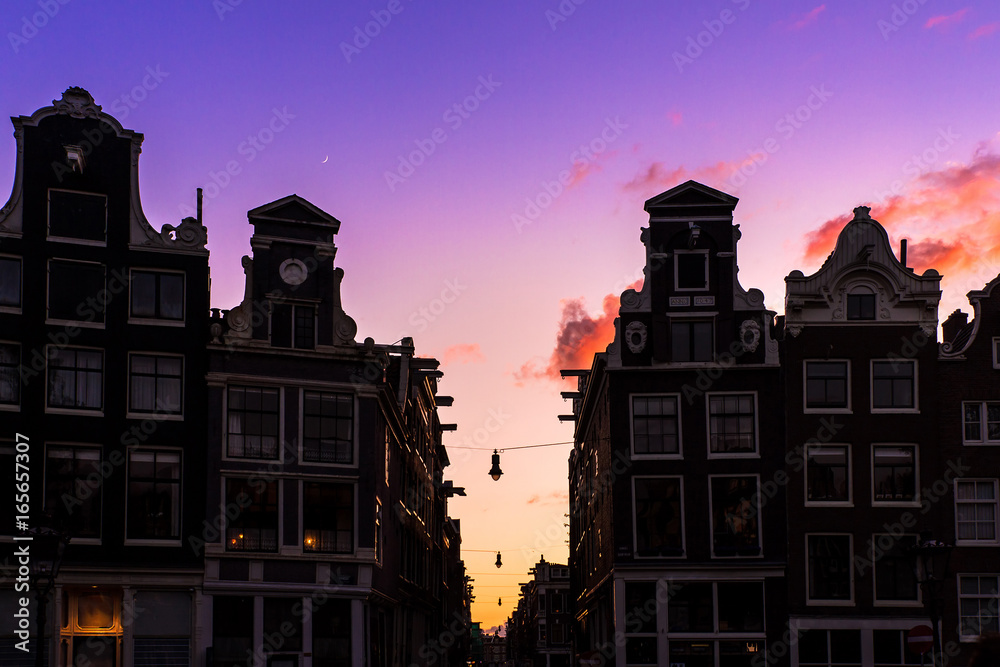 Beautiful silhouettes of canal houses at the little nine streets in Amsterdam, the Netherlands, at sunset