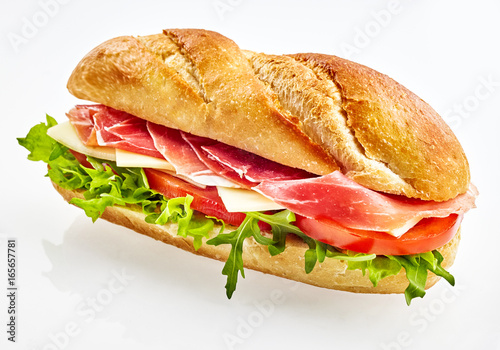 Baguette sandwich with serrano ham, cheese and vegetables