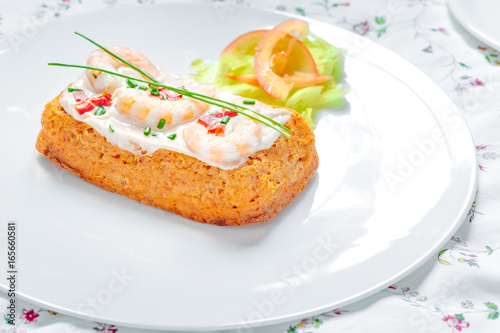 Delicious spanish Fish cake. Hake cake with tuna  tomato  shrimps  chive and salad cream.