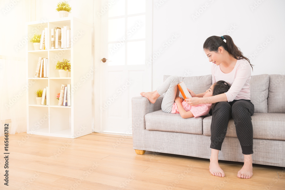 mother sitting on the couch with daughter mother sitting on the couch with daughter