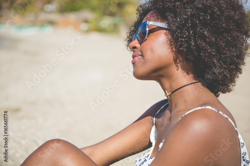 Young afro american woman relaxing on beach