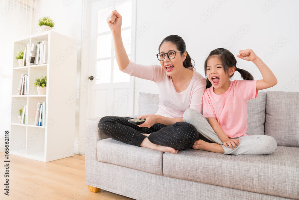 young mother and daughter sitting on the sofa