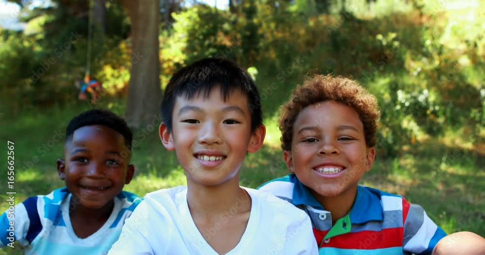 Portrait of happy kids sitting in park Portrait of happy kids sitting in park