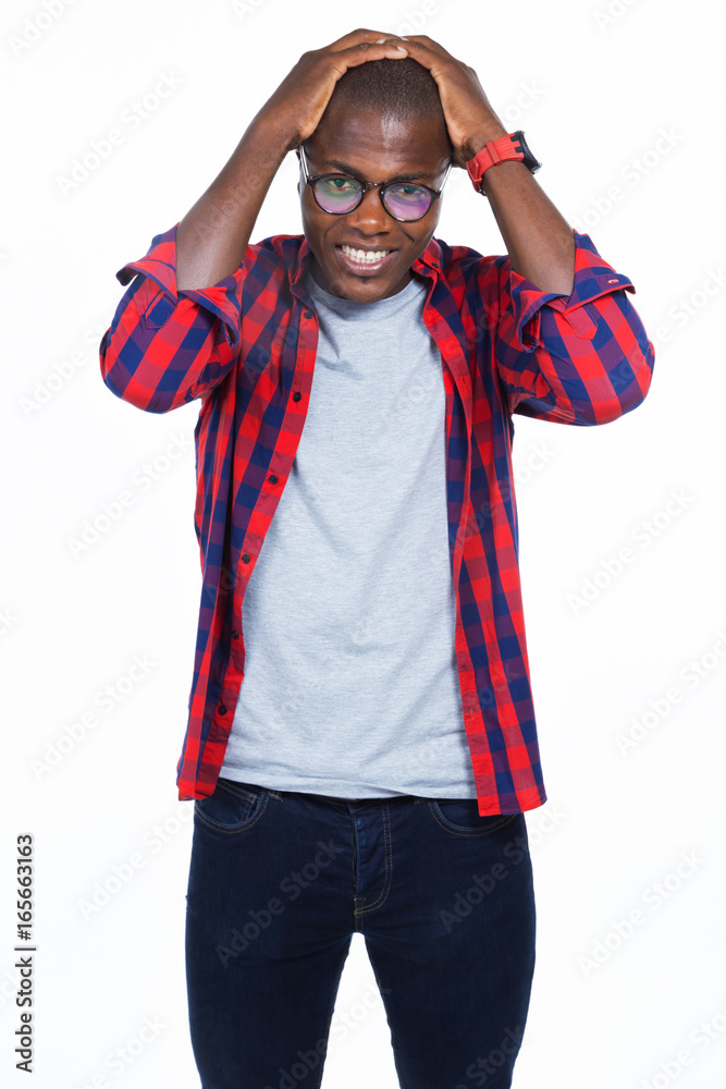 Fototapeta premium Handsome young man with hands on head. Isolated on white.
