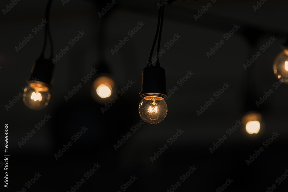 Retro light bulb hanging with dark space background for your decoration, concept of creativity Retro light bulb hanging with dark space background for your decoration, concept of creativity
