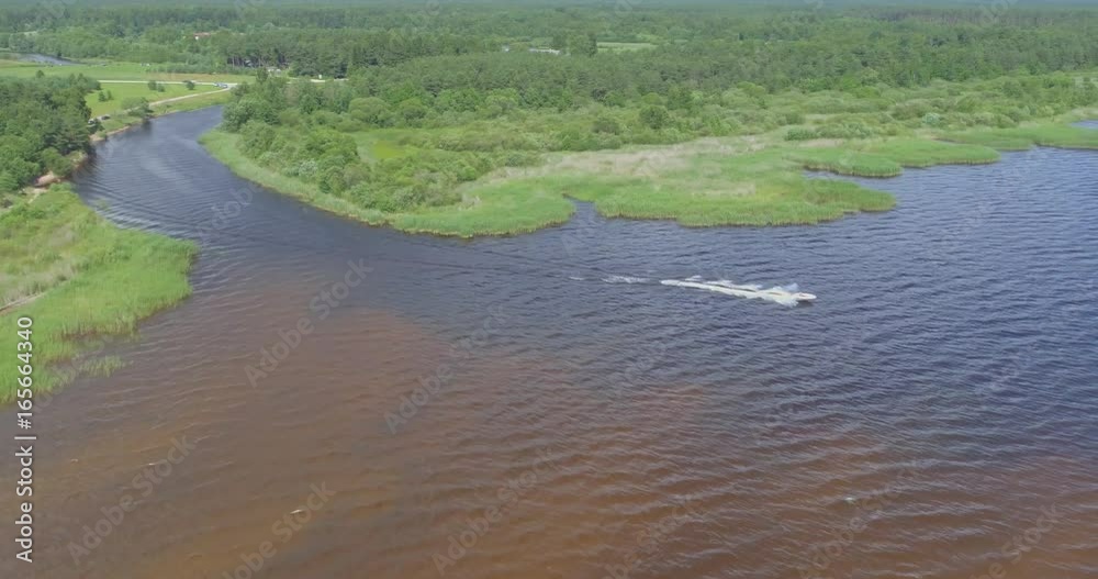 Aerial view of luxury speed boat cruising in the lake. Aerial view of luxury speed boat cruising in the lake.