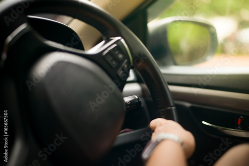 Blurred hand driving in the car. © toeytoey