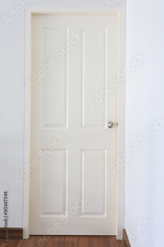 white wood pane door closed and silver knob lock in industrial building house