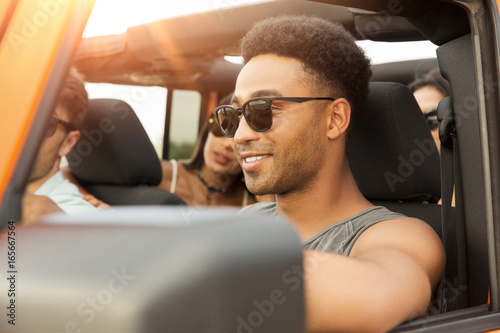Smiling young african man driving a car © Drobot Dean