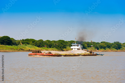 Cargo barge on the Irrawaddy river  Bagan  Myanmar  Burma. Copy space for text.