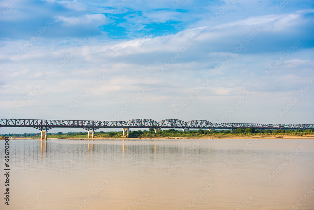 Steel bridge over the Irrawaddy river in Mandalay, Myanmar, Burma. Copy space for text.