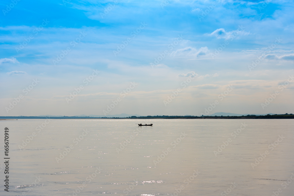 Fishermen in a boat on the river Irrawaddy in Mandalay, Myanmar, Burma. Copy space for text.