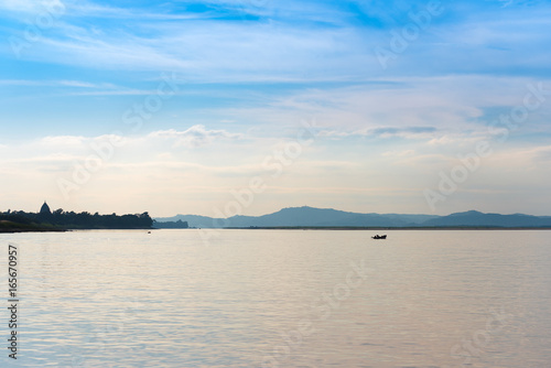 Fishermen in a boat on the river Irrawaddy in Mandalay, Myanmar, Burma. Copy space for text. © ggfoto