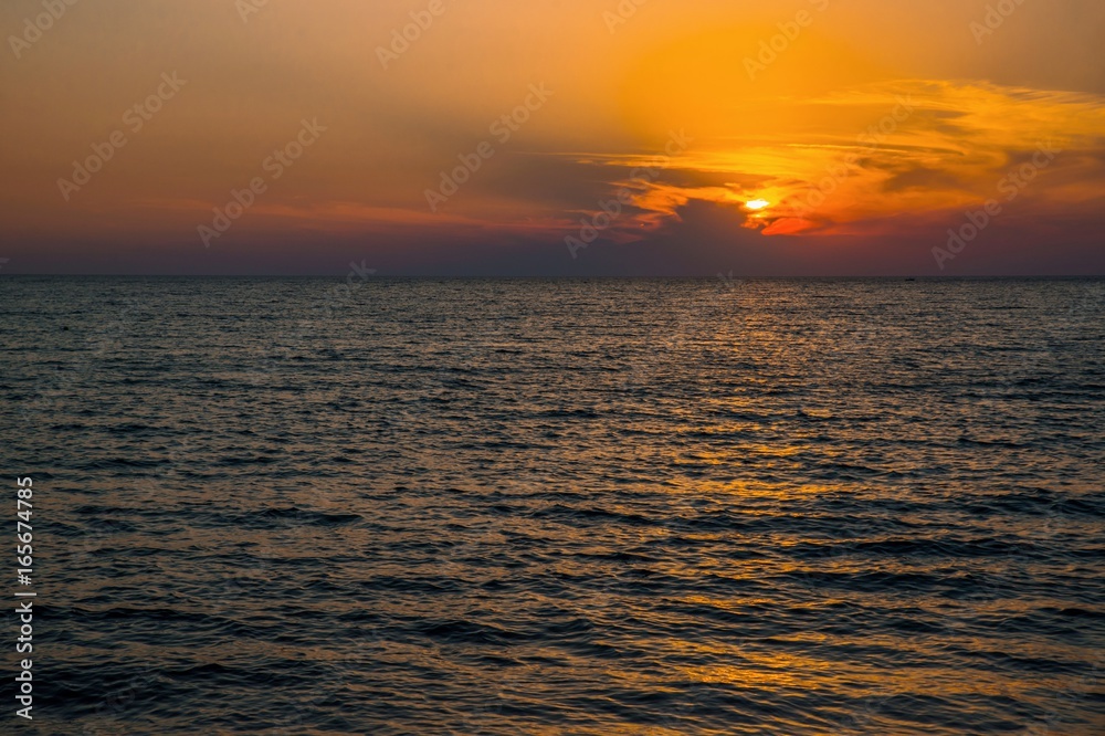 Fototapeta premium Orange sunset above Aegean sea, island Lemnos.