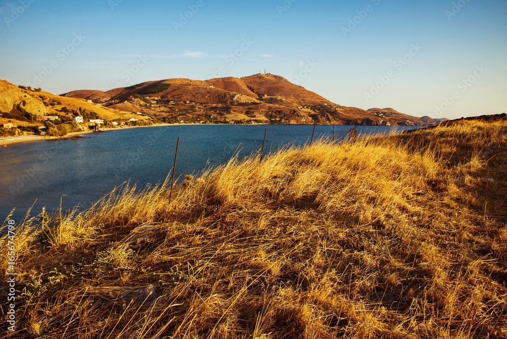 Landscape with golden hill and sea near Kaspakas, Lemnos, Greece.