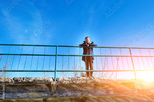 On a concrete bridge there is a calm happy woman who enjoys hiki © cezarksv