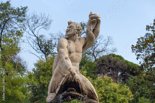 GENOA (GENOVA) ITALY, JULY, 19, 2017 - Triton statue in the the garden of the Prince's Palace, Andrea Doria's Palace in Genoa (Genova), Italy photo
