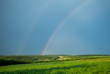 Beautiful summer landscape. Rainbow in the sky. A bright sunny day.