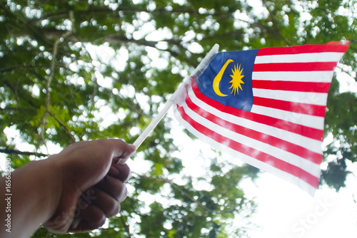 Independence Day concept - Hand Holding Malaysian Flag photo