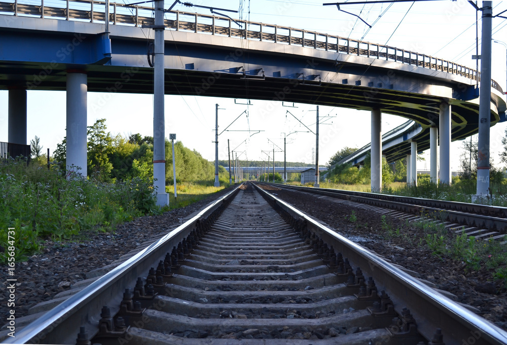 Railroad tracks under the automobile overpass
