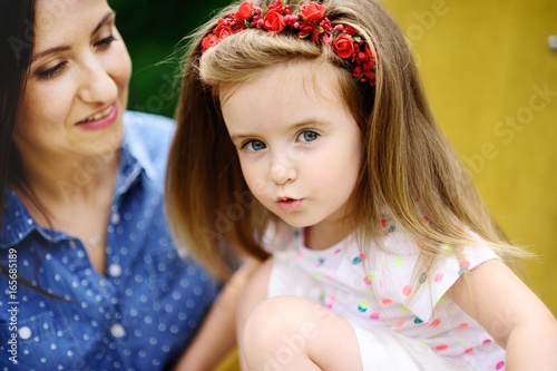 Portrait of the little girl with mother.