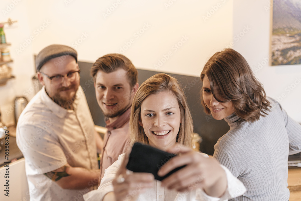 Friends taking selfie with smartphone at home Friends taking selfie with smartphone at home