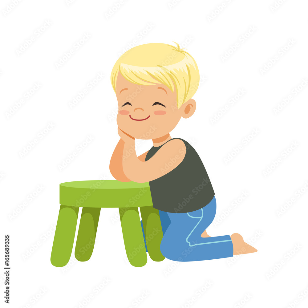 Sweet smiling little boy sitting on the floor leaning on a small green stool, colorful character Sweet smiling little boy sitting on the floor leaning on a small green stool, colorful character