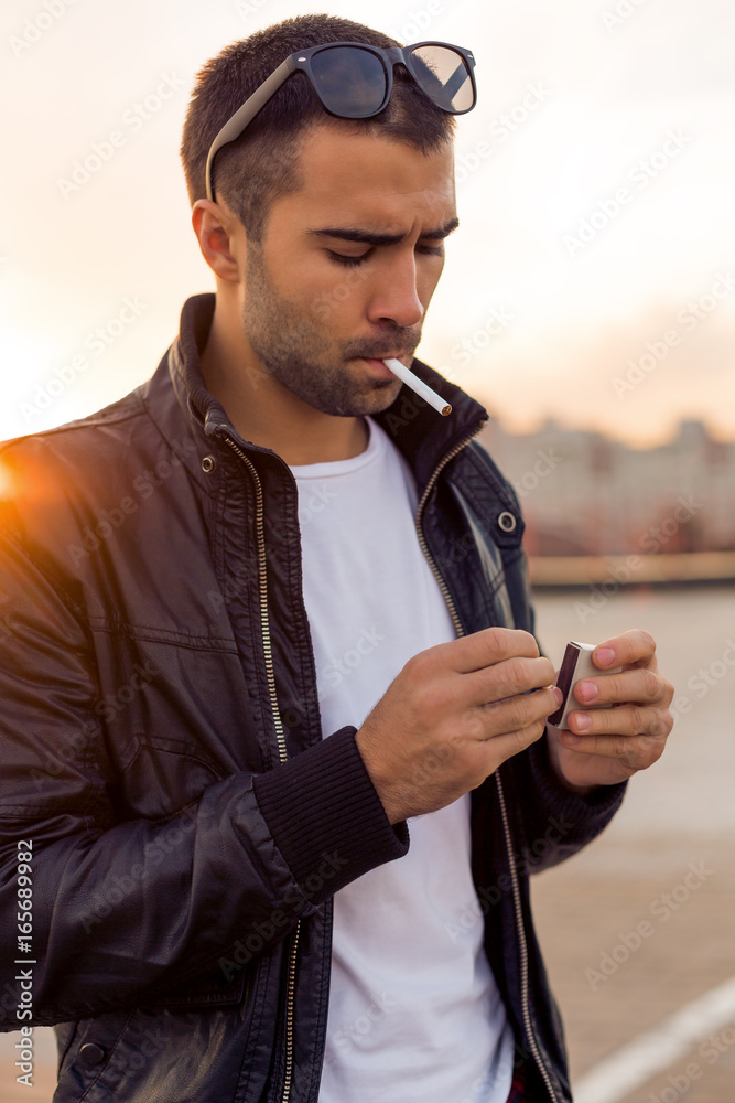 Close up portrait of a handsome rider man with beard and mustache in black  biker jacket,