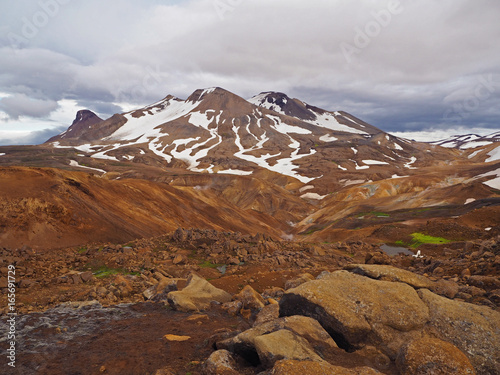 colourfull rhyoliet Kerlingarfjöll volcanic mountains in geothermal area in iceland with snow tangues and green moss photo