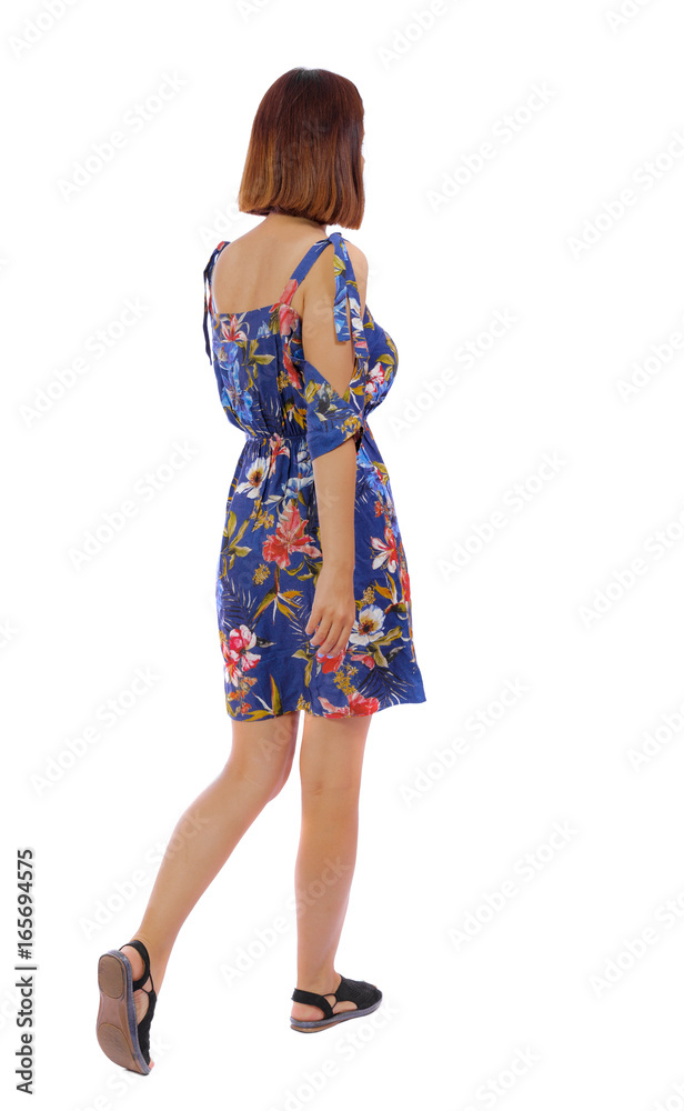 back view of walking woman. beautiful blonde girl in motion. backside view of person. Rear view people collection. Isolated over white background. The girl in a dress in a flower leaves sideways back view of walking woman. beautiful blonde girl in motion. backside view of person. Rear view people collection. Isolated over white background. The girl in a dress in a flower leaves sideways