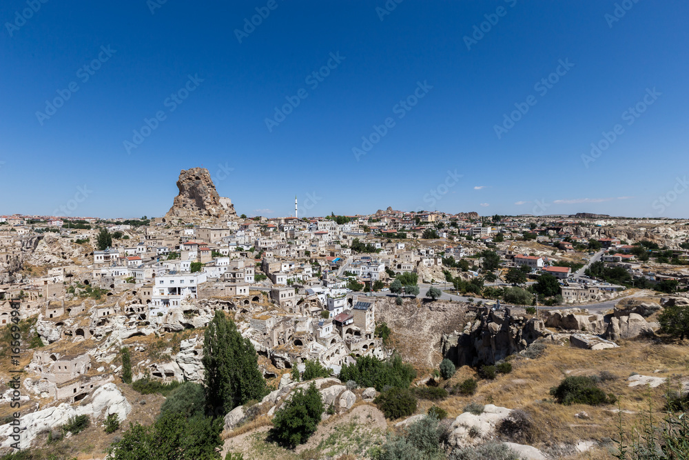 View of ancient Nevsehir cave town and a castle of Uchisar dug from a mountains in Cappadocia, Central Anatolia,Turkey. Cappadocia,Kapadokya,Turkish heritage travel. Uchisar pigeon valley.