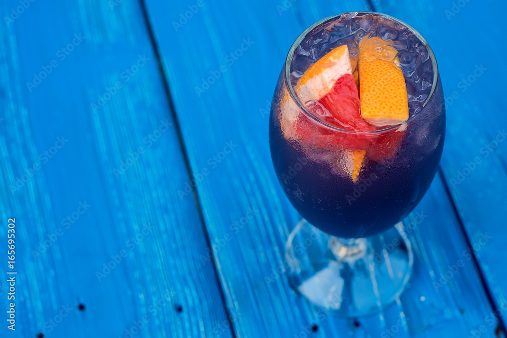 Dark restaurant cocktail with grapefruit