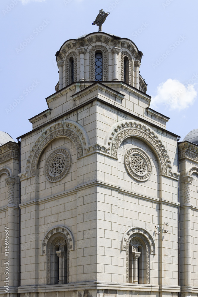 Part of facade, dome, rosette and bifora of the Orthodox church with ornaments, frieze, relief, cornice. Serbia.