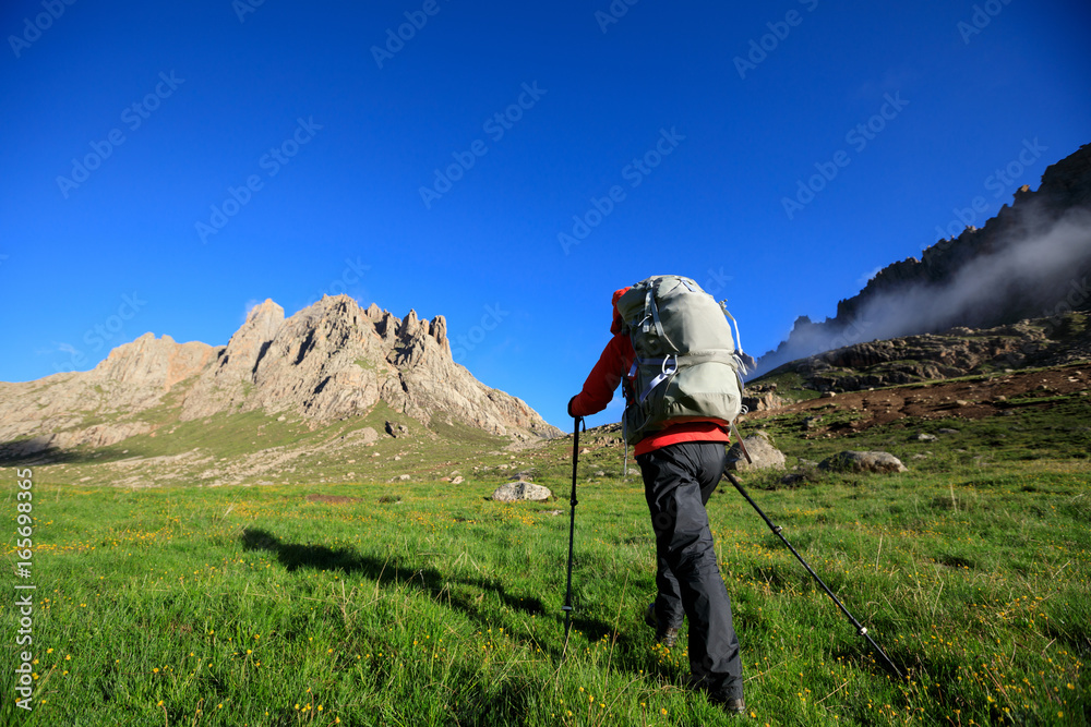 woman with backpack hiking in mountains travel lifestyle concept adventure active vacations outdoor mountaineering sports landscape