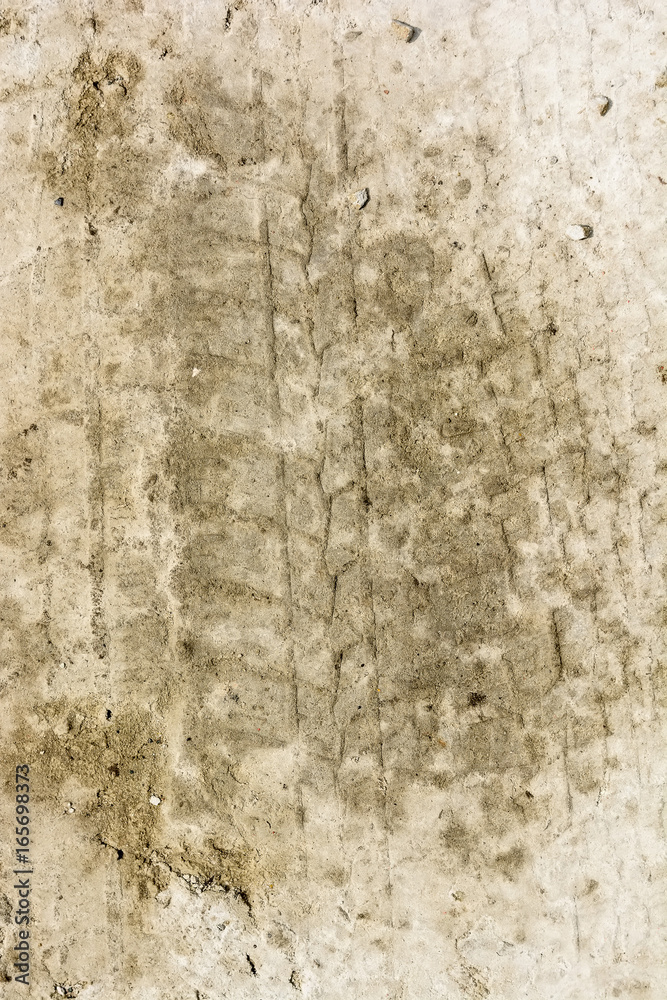 Fototapeta premium Close up muddy tire track on the ground