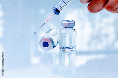 Syringe, medical injection Liquid drug or narcotic in hand.