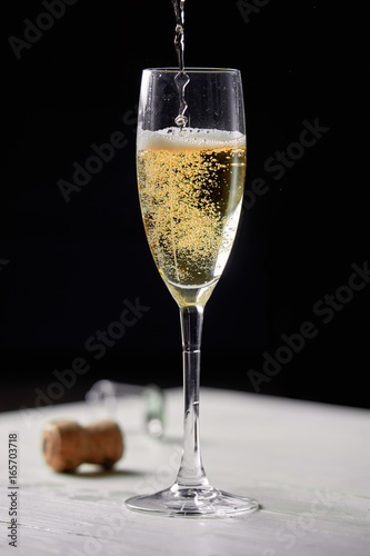 A glass of champagne on a black background