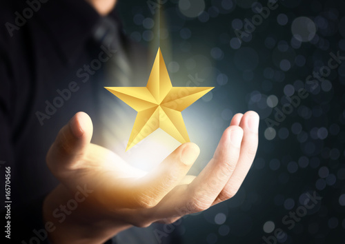 businessman holding excellence star photo