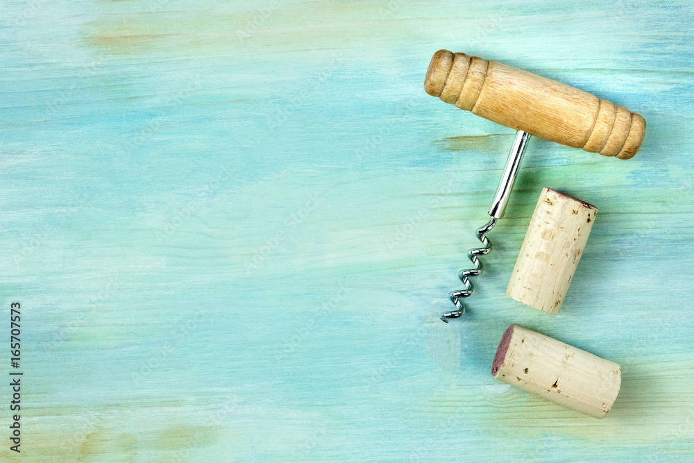 Vintage corks and corkscrew on teal with copy space