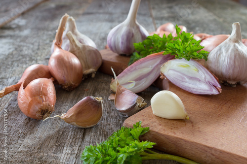 Shallot onion and garlic on a wooden background