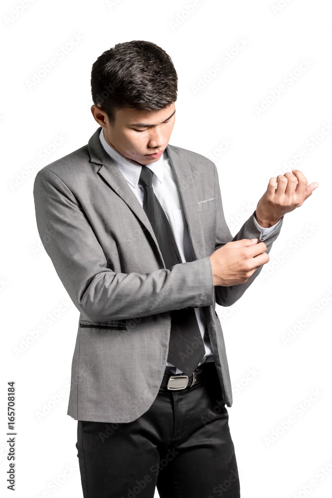 Portrait of an asian business man adjusting his sleeves while standing. Isolated on white background with copy space and clipping path Portrait of an asian business man adjusting his sleeves while standing. Isolated on white background with copy space and clipping path
