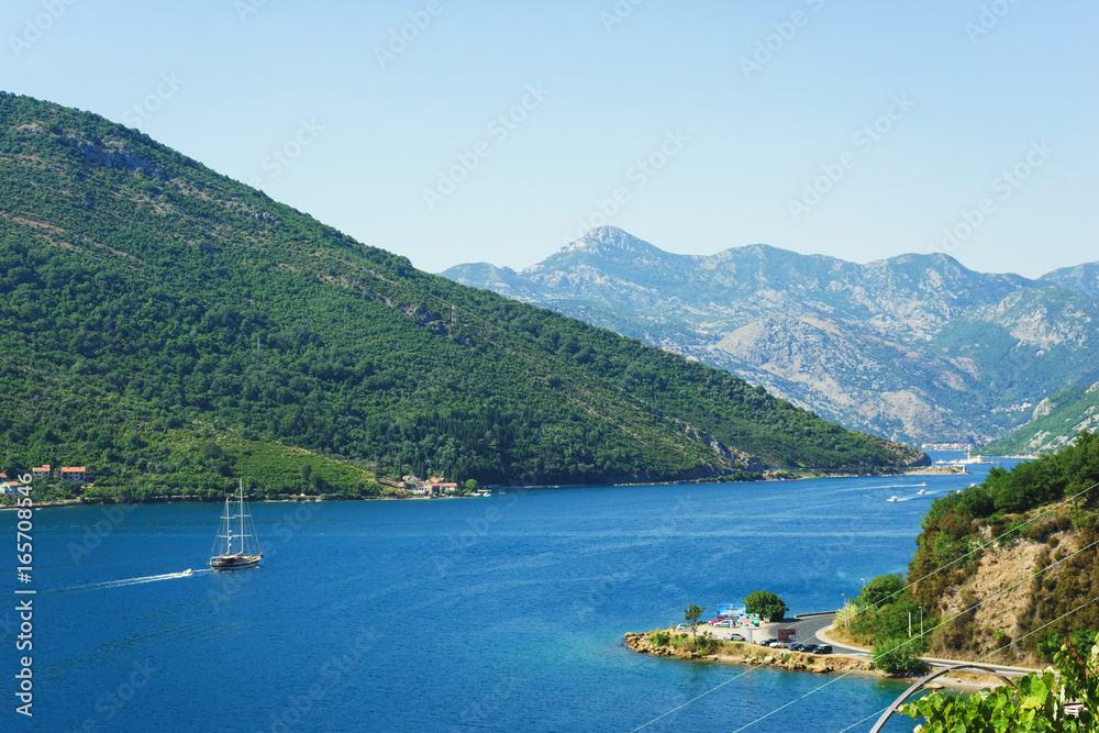 View of Boko Kotorska bay in Montenegro on a hot summer day. Vacation on the beach, the morning landscape in the bay.