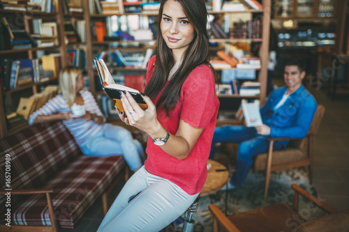 Students reading books in library