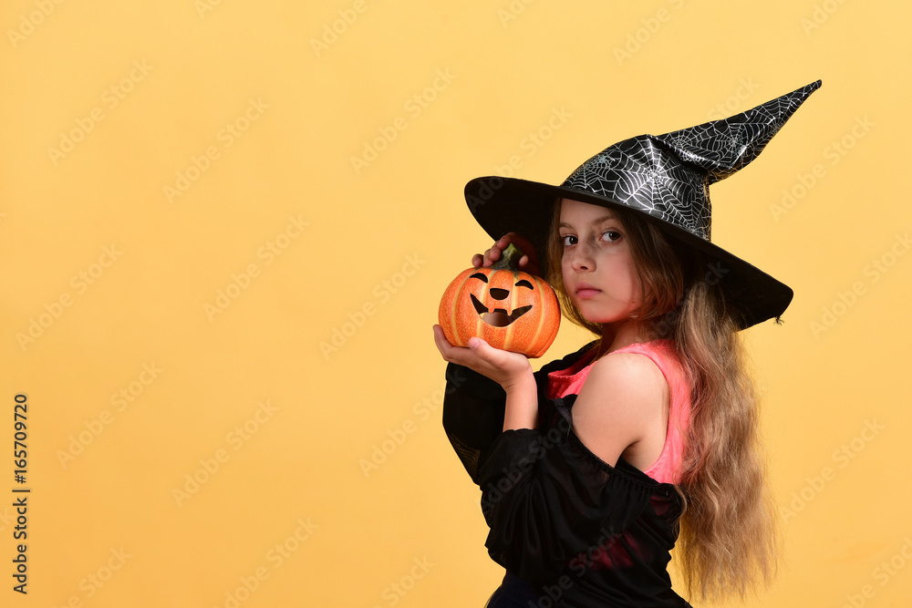 Child in witch costume and jack o lantern Child in witch costume and jack o lantern