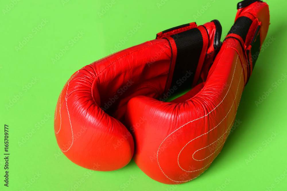 Sport equipment isolated on green background. Pair of boxing sportswear
