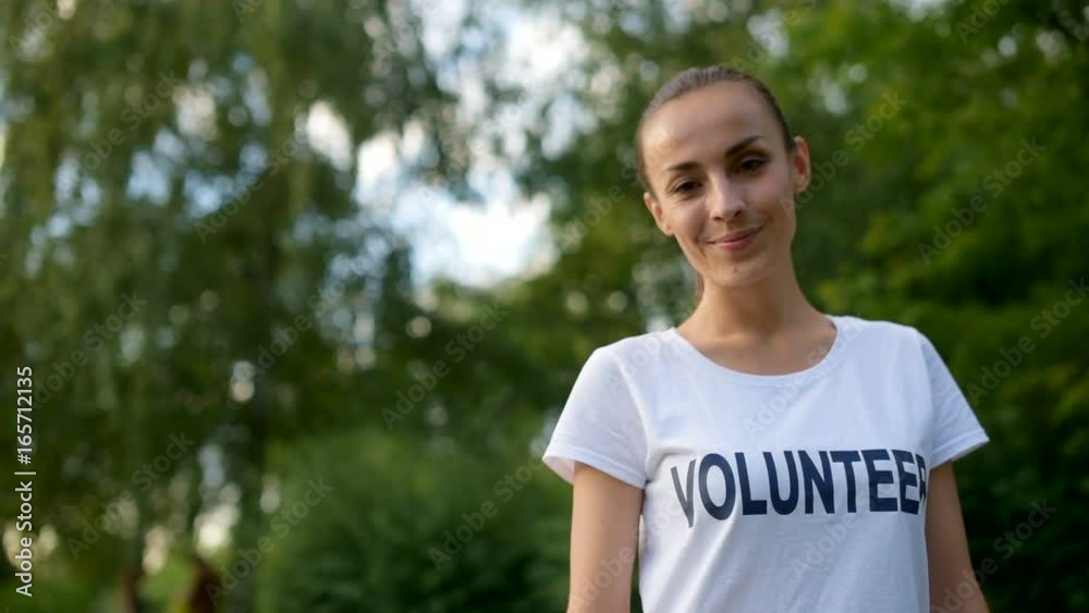Charming female volunteer smiling for camera Charming female volunteer smiling for camera